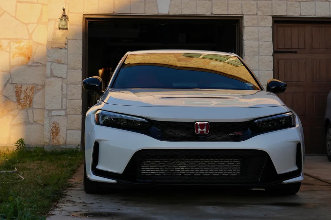Orange performance hatchback parked outdoors